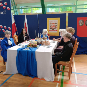 Uczta królewska - pani Dyrektor Joanna Ozorka-Krawczyk w towarzystwie uczniów przebranych w stroje z czasów króla Poniatowskiego. Kliknięcie na zdjęcie spowoduje jego powiększenie do rozmiaru oryginalnego
