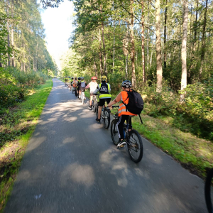 Uczniowie klas 5 jadą na rowerach. Kliknięcie na zdjęcie spowoduje jego powiększenie do rozmiaru oryginalnego.