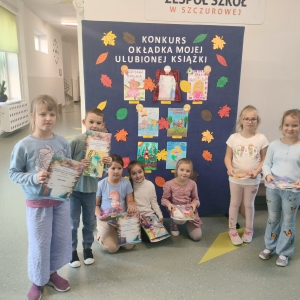 Pierwszoklasiści przy sztaludze z pracami konkursowymi. Kliknięcie na zdjęcie spowoduje jego powiększenie do rozmiaru oryginalnego. 