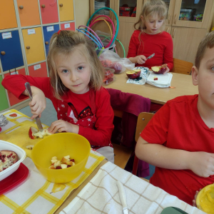 Uczniowie z klasy 1 a w trakcie krojenia czerwonych owoców. Kliknięcie na zdjęcie spowoduje jego powiększenie do rozmiaru oryginalnego.
