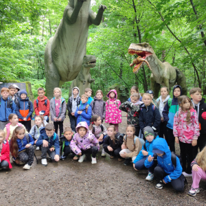 Nauczyciele wraz z uczniami pod figurami dinozaurów w Zatorlandzie. Kliknięcie na zdjęcie spowoduje jego powiększenie do rozmiaru oryginalnego.