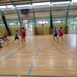 Reprezentacja chłopców gra w koszykówkę na hali sportowej. Klikniecie na zdjęcie spowoduje jego powiększenie do rozmiaru oryginalnego.